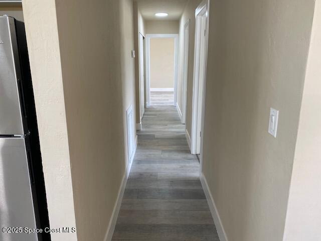 3037 Rowe St NE, Palm Bay, FL 32905 - corridor featuring wood finished floors and baseboards