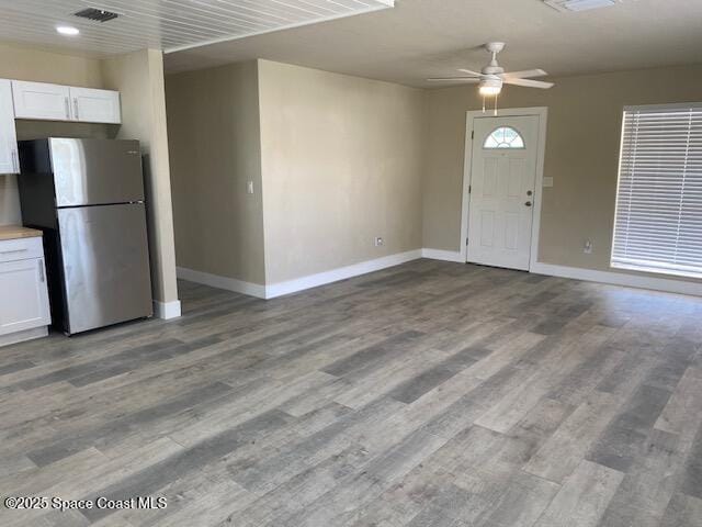 3037 Rowe St NE, Palm Bay, FL 32905 - unfurnished living room featuring wood finished floors and ceiling fan