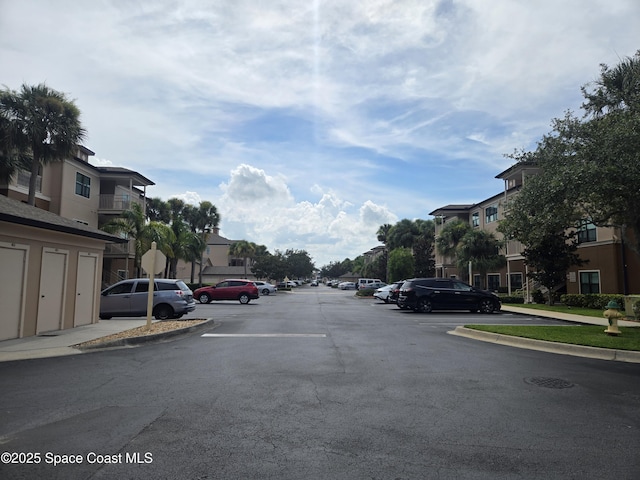 6470 Borasco Dr Unit 2102, Melbourne, FL 32940 - view of asphalt road with a residential view, curbs, and traffic signs