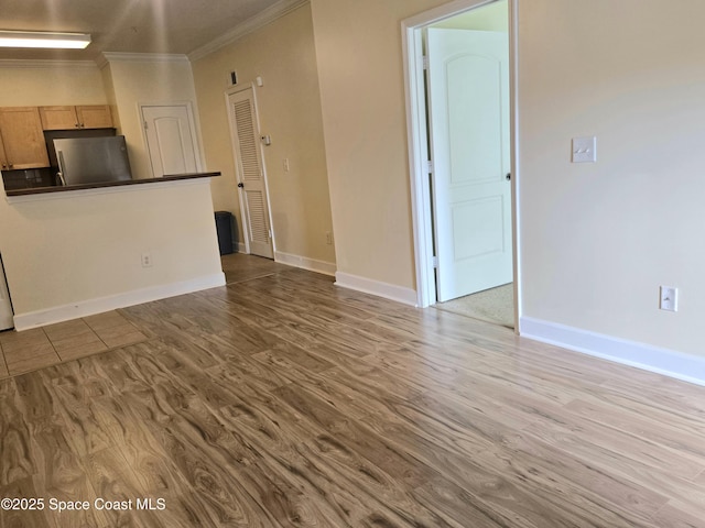 6470 Borasco Dr Unit 2102, Melbourne, FL 32940 - unfurnished living room with crown molding and wood finished floors