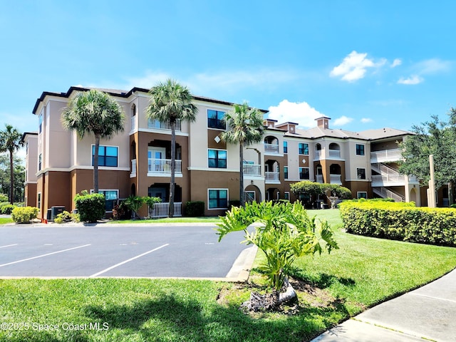 6470 Borasco Dr Unit 2102, Melbourne, FL 32940 - view of apartment building / complex featuring uncovered parking