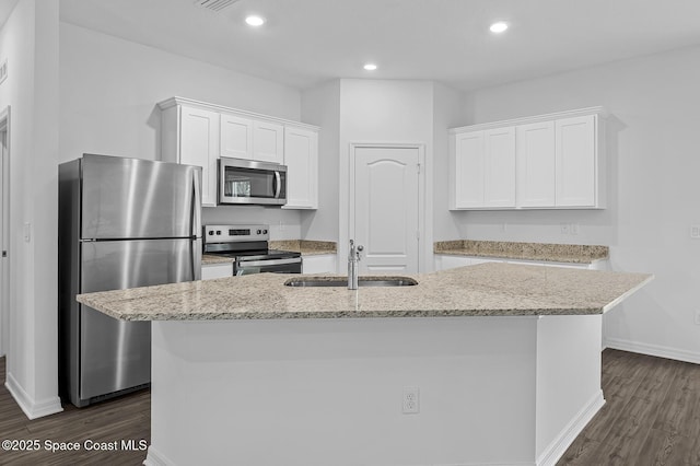 2206 Hialeah St, Palm Bay, FL 32907 - kitchen featuring appliances with stainless steel finishes, dark wood-style floors, white cabinetry, a kitchen island with sink, and recessed lighting