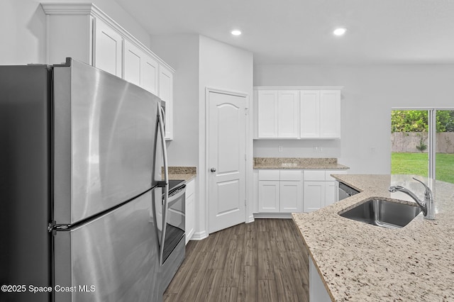 2206 Hialeah St, Palm Bay, FL 32907 - kitchen featuring stainless steel appliances, white cabinets, recessed lighting, dark wood-style floors, and light stone countertops