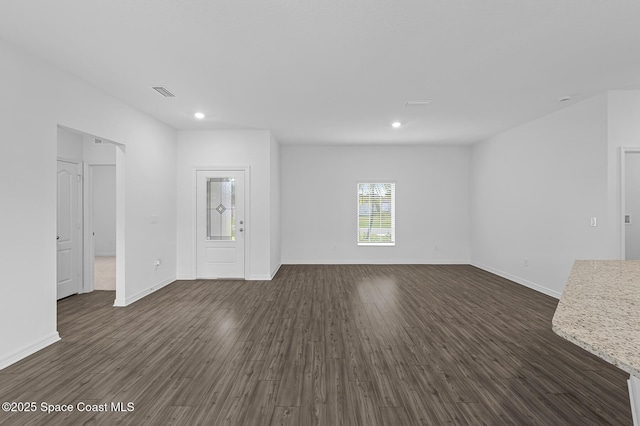 2206 Hialeah St, Palm Bay, FL 32907 - unfurnished living room featuring dark wood-style floors and recessed lighting