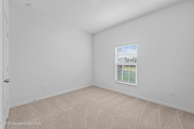 2206 Hialeah St, Palm Bay, FL 32907 - carpeted spare room featuring baseboards and a smoke detector