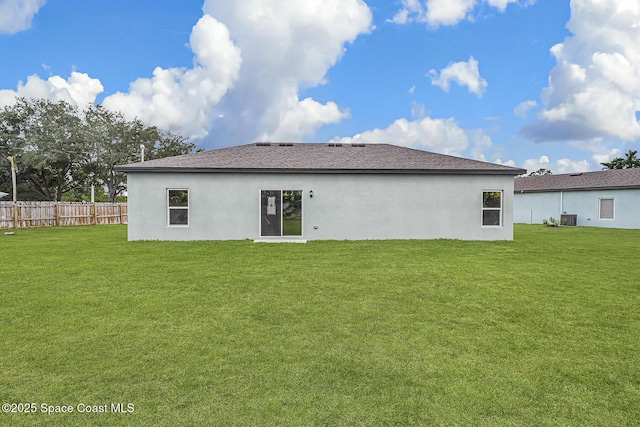 2206 Hialeah St, Palm Bay, FL 32907 - rear view of house featuring stucco siding and roof with shingles