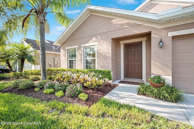 103 Amherst Ln, Sebastian, FL 32958 - entrance to property featuring stucco siding and an attached garage