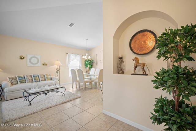103 Amherst Ln, Sebastian, FL 32958 - living room featuring light tile patterned floors, a chandelier, and vaulted ceiling