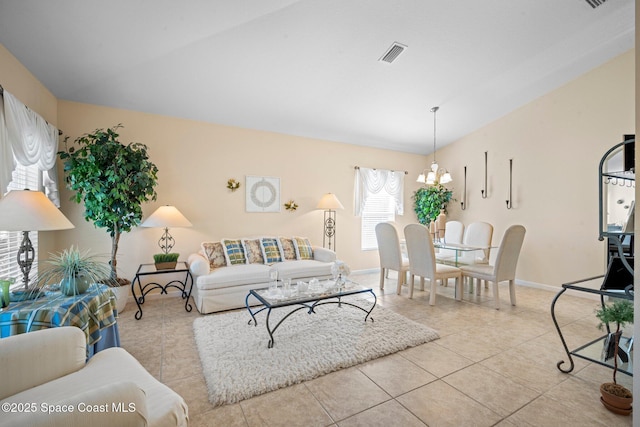 103 Amherst Ln, Sebastian, FL 32958 - living area with vaulted ceiling, a chandelier, and tile patterned floors