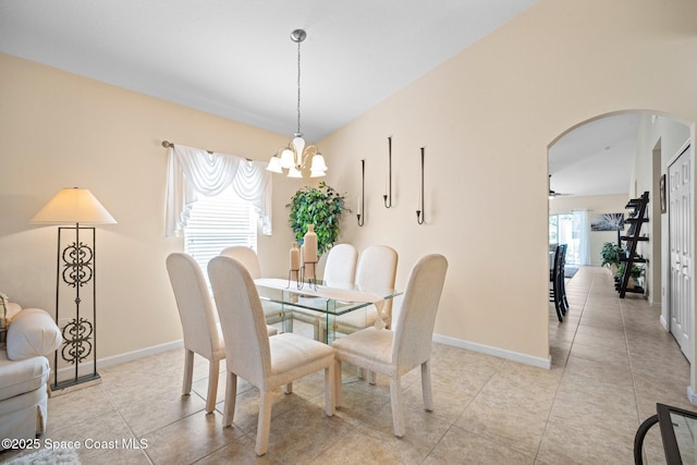103 Amherst Ln, Sebastian, FL 32958 - dining space featuring arched walkways, a chandelier, and light tile patterned flooring