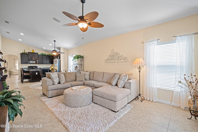 103 Amherst Ln, Sebastian, FL 32958 - living room featuring ceiling fan, arched walkways, light tile patterned floors, and vaulted ceiling
