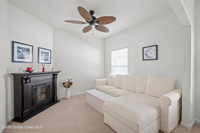 103 Amherst Ln, Sebastian, FL 32958 - carpeted living room with a ceiling fan, a glass covered fireplace, and arched walkways