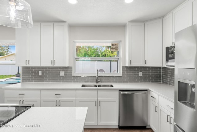 1119 Manatee Dr, Rockledge, FL 32955 - kitchen with appliances with stainless steel finishes, light countertops, white cabinetry, and recessed lighting