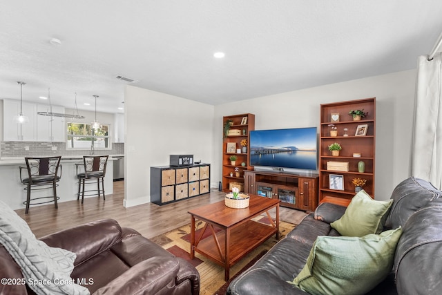 1119 Manatee Dr, Rockledge, FL 32955 - living room featuring light wood finished floors and recessed lighting
