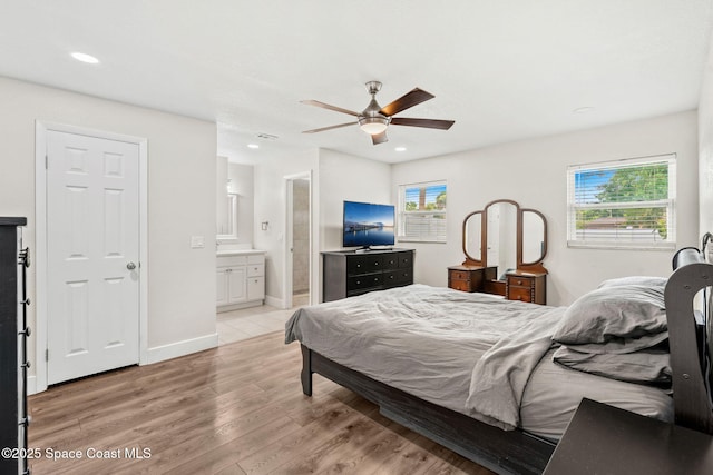1119 Manatee Dr, Rockledge, FL 32955 - bedroom with multiple windows, light wood-style floors, recessed lighting, ensuite bath, and ceiling fan