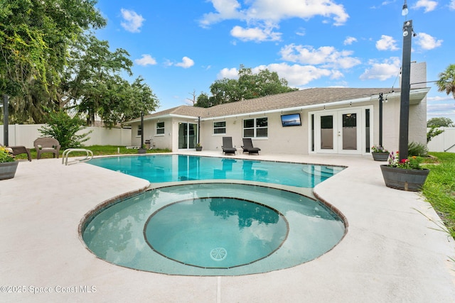 1119 Manatee Dr, Rockledge, FL 32955 - view of pool with a pool with connected hot tub, a patio area, a fenced backyard, and french doors