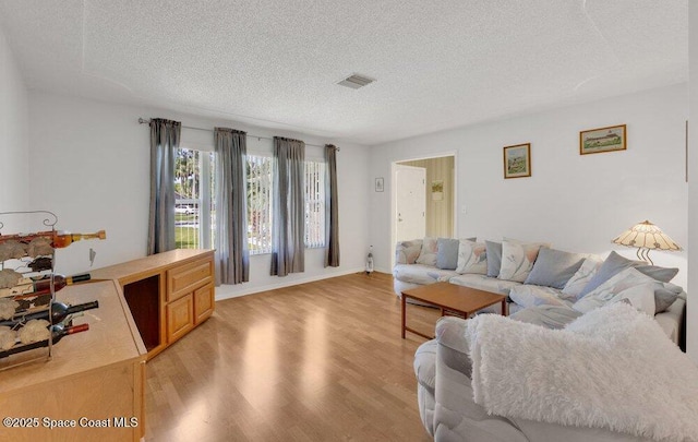 631 Dundee Cir, Melbourne, FL 32904 - living area with a textured ceiling and light wood-style floors