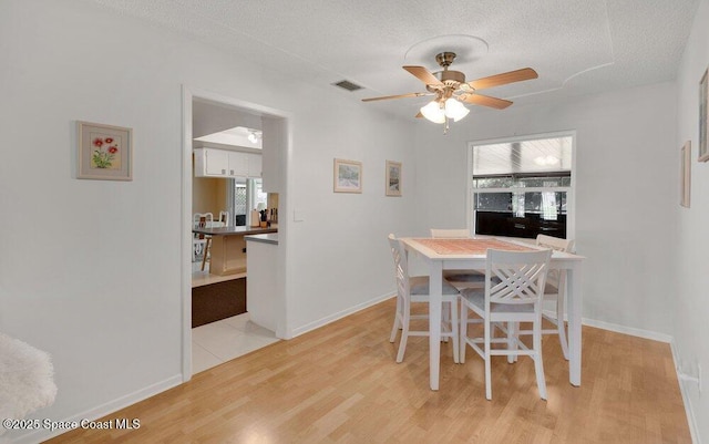 631 Dundee Cir, Melbourne, FL 32904 - dining room featuring a ceiling fan, light wood-type flooring, and a textured ceiling