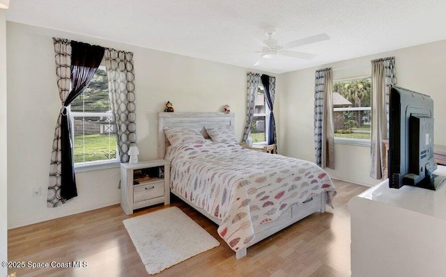 631 Dundee Cir, Melbourne, FL 32904 - bedroom featuring multiple windows, wood finished floors, and a ceiling fan