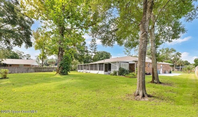 631 Dundee Cir, Melbourne, FL 32904 - view of yard with a sunroom