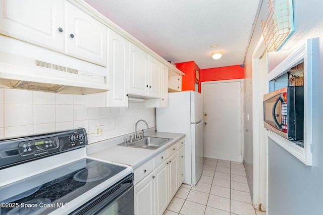 390 W Cocoa Beach Cswy Unit 11-2, Cocoa Beach, FL 32931 - kitchen with white appliances, white cabinets, under cabinet range hood, and tasteful backsplash