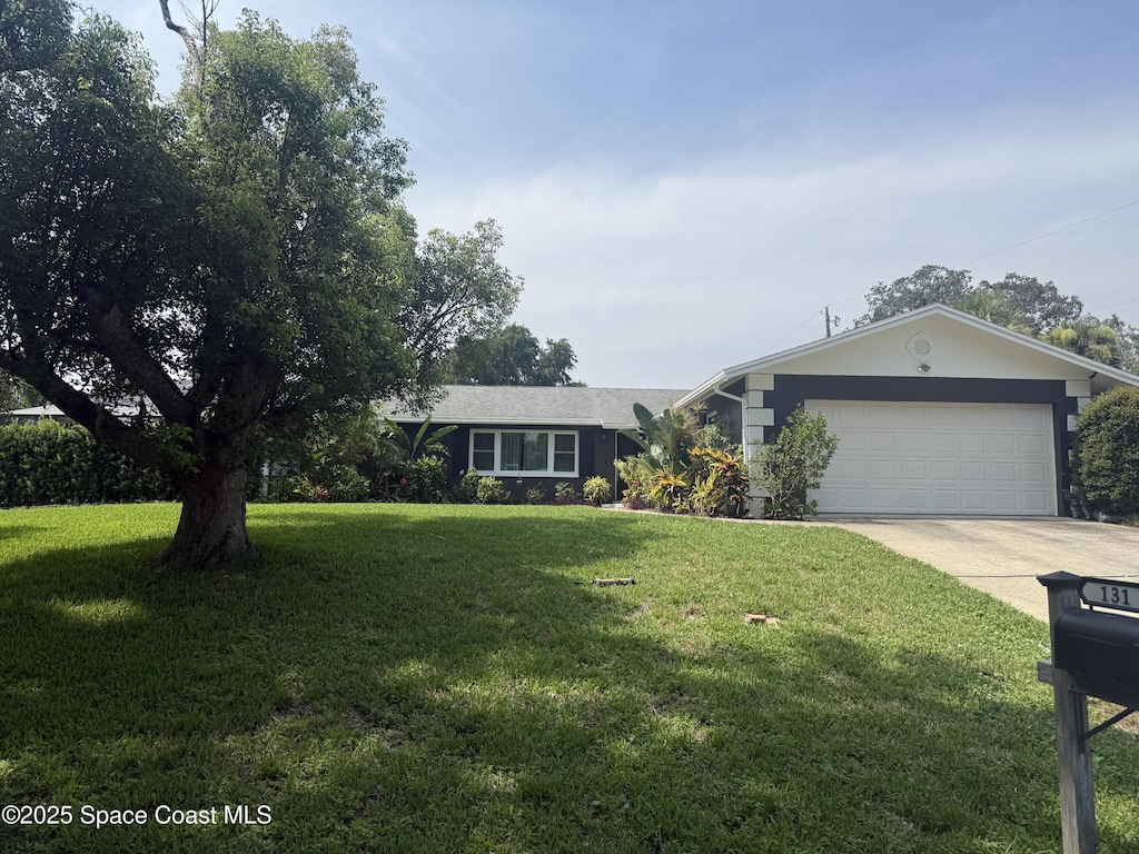 131 Briarwood Ln, Cocoa, FL 32926 - single story home with concrete driveway, a garage, and a front lawn