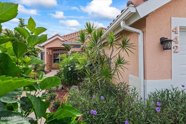 442 Carmel Dr, Melbourne, FL 32940 - view of side of property with stucco siding