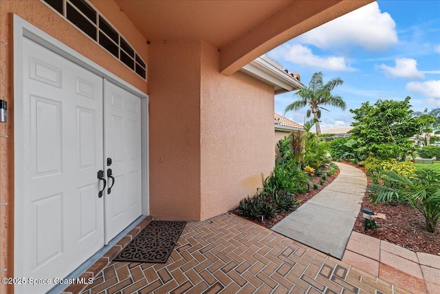 442 Carmel Dr, Melbourne, FL 32940 - entrance to property featuring stucco siding