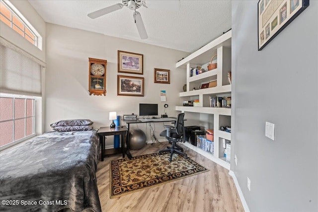 442 Carmel Dr, Melbourne, FL 32940 - home office with wood finished floors, ceiling fan, a textured ceiling, and built in features