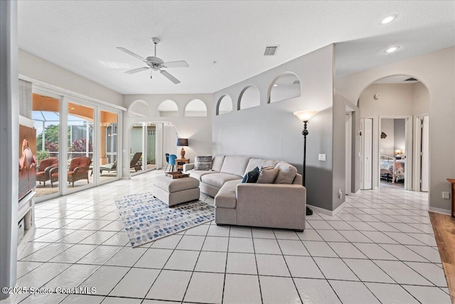 442 Carmel Dr, Melbourne, FL 32940 - living area featuring arched walkways, ceiling fan, light tile patterned flooring, and recessed lighting