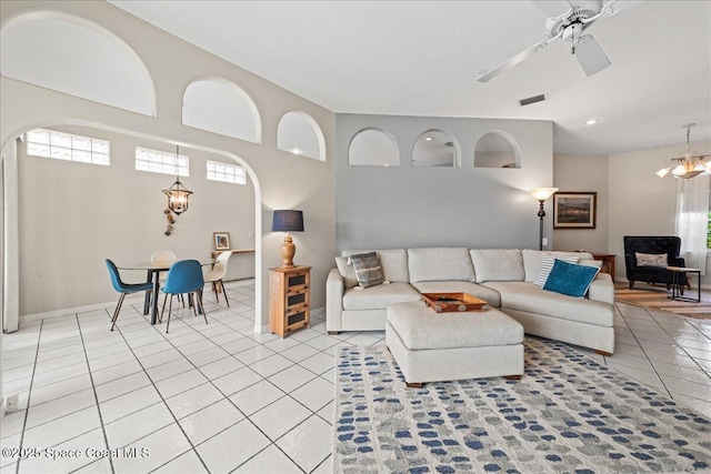 442 Carmel Dr, Melbourne, FL 32940 - living area featuring arched walkways, light tile patterned floors, and a ceiling fan