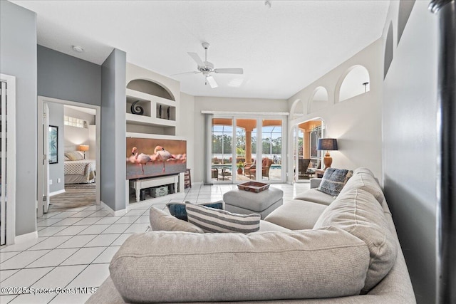 442 Carmel Dr, Melbourne, FL 32940 - living room with light tile patterned floors, ceiling fan, and built in features