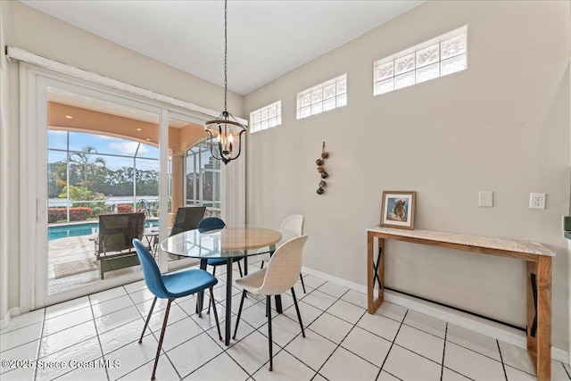 442 Carmel Dr, Melbourne, FL 32940 - dining area featuring a chandelier and light tile patterned floors