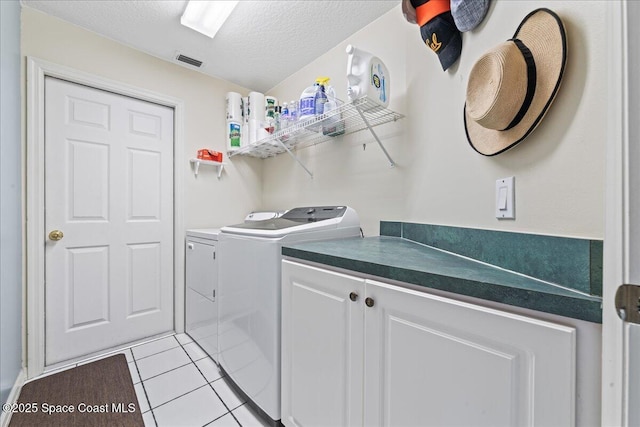442 Carmel Dr, Melbourne, FL 32940 - laundry area with washing machine and dryer, light tile patterned floors, and a textured ceiling