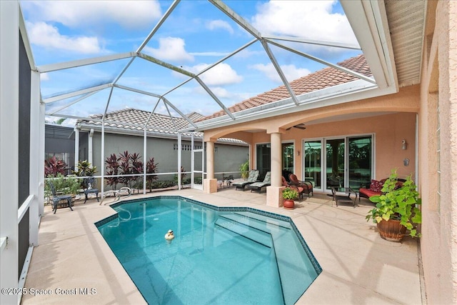 442 Carmel Dr, Melbourne, FL 32940 - outdoor pool featuring a patio area, a ceiling fan, and glass enclosure