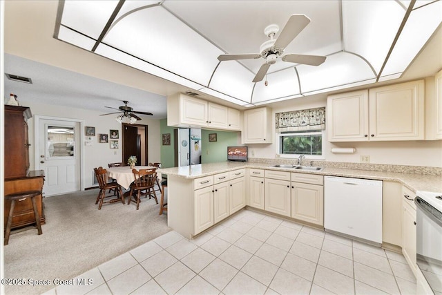 822 Berkshire Dr, Rockledge, FL 32955 - kitchen with ceiling fan, white appliances, a peninsula, and light colored carpet