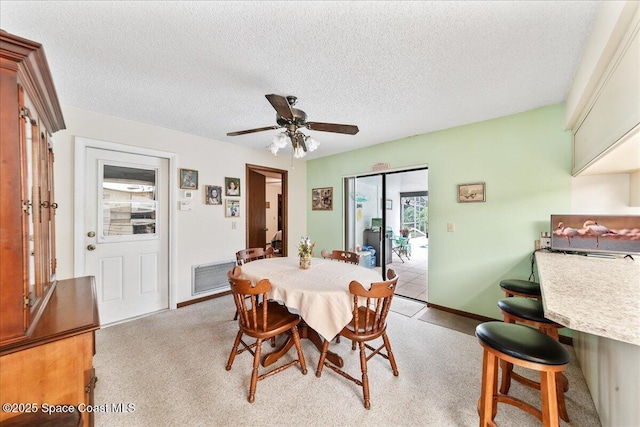 822 Berkshire Dr, Rockledge, FL 32955 - dining area featuring ceiling fan, light carpet, and a textured ceiling
