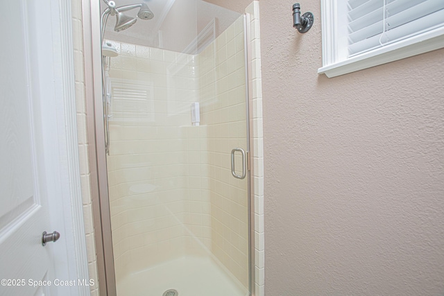 110 Windsong Way, Titusville, FL 32780 - full bathroom featuring a shower stall and a textured wall