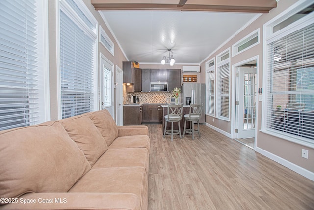 110 Windsong Way, Titusville, FL 32780 - living room with ornamental molding, light wood-style flooring, and a chandelier