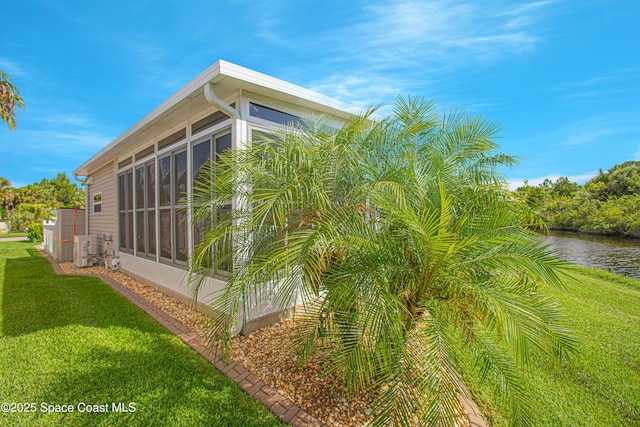 110 Windsong Way, Titusville, FL 32780 - view of home's exterior featuring a sunroom, a yard, and a water view
