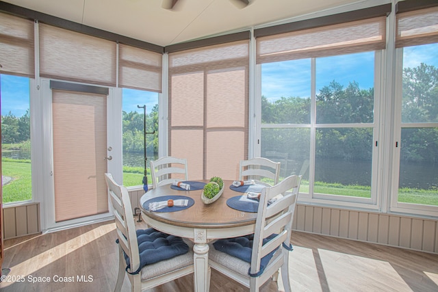110 Windsong Way, Titusville, FL 32780 - sunroom featuring wood finished floors, view of wooded area, a water view, and plenty of natural light