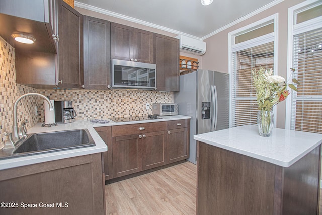 110 Windsong Way, Titusville, FL 32780 - kitchen featuring appliances with stainless steel finishes, a wall mounted air conditioner, crown molding, light wood-type flooring, and tasteful backsplash