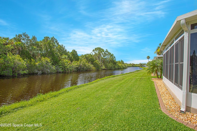 110 Windsong Way, Titusville, FL 32780 - view of grassy yard with a water view and a sunroom