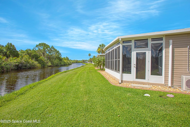110 Windsong Way, Titusville, FL 32780 - view of green lawn with a sunroom and a water view