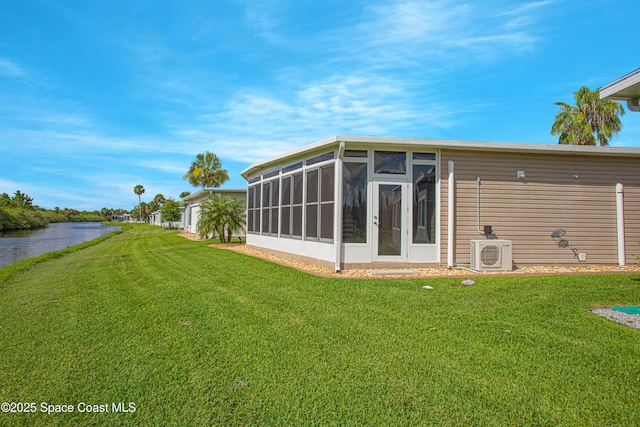 110 Windsong Way, Titusville, FL 32780 - back of property featuring a sunroom, a lawn, and a water view