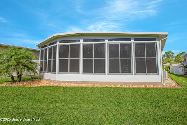 110 Windsong Way, Titusville, FL 32780 - rear view of house with a sunroom and a yard