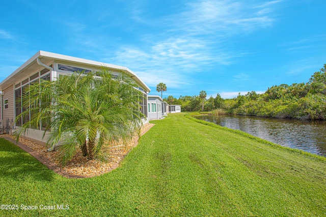 110 Windsong Way, Titusville, FL 32780 - view of grassy yard featuring a sunroom and a water view
