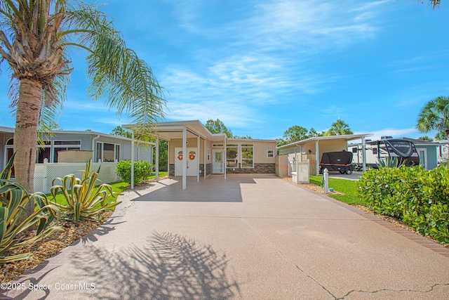 110 Windsong Way, Titusville, FL 32780 - manufactured / mobile home with driveway and stone siding