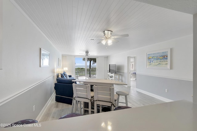 2101 S Atlantic Ave Unit 205, Cocoa Beach, FL 32931 - dining room featuring wood ceiling, light wood-style floors, and ceiling fan