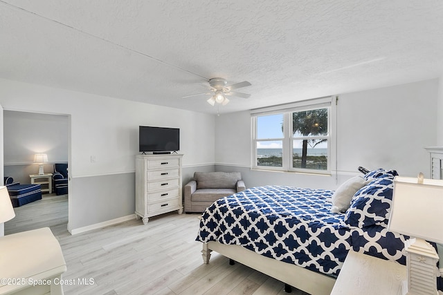 2101 S Atlantic Ave Unit 205, Cocoa Beach, FL 32931 - bedroom with wood finished floors, a textured ceiling, and ceiling fan